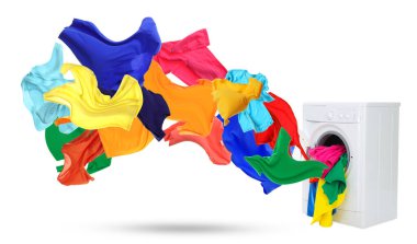 Beyaz arka planda çamaşır makinesinden fırlayan temiz renkli elbiseler.