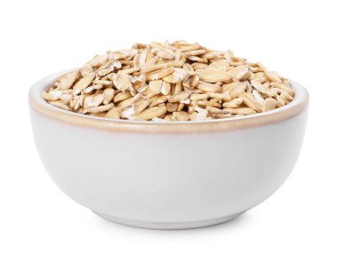 Beyaz tenceredeki kuru yulaf ezmesi.