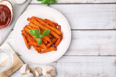 Tatlı patates kızartması, fesleğen, ketçap ve bir bardak su. Metin için boşluk