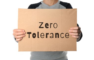 Woman holding piece of cardboard with words Zero Tolerance on white background, closeup clipart