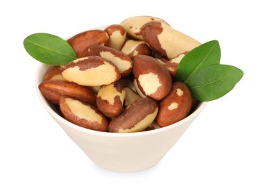 Tasty Brazil nuts and green leaves in bowl isolated on white clipart