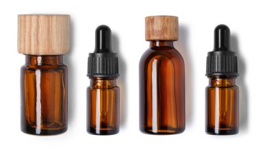 Essential oils in different bottles on white background, top view clipart