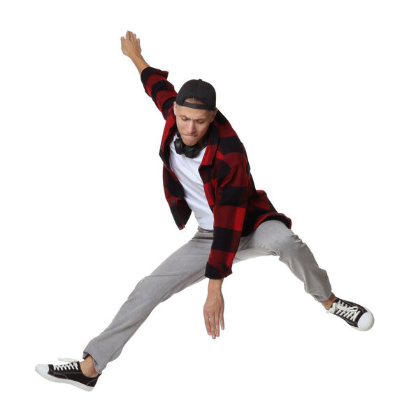 Handsome young skater jumping on white background