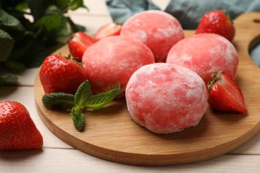 Delicious mochi, strawberries and mint on wooden table, closeup clipart