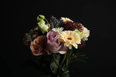 Bouquet of beautiful flowers on black background