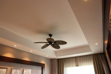 Modern ceiling fan indoors, low angle view clipart