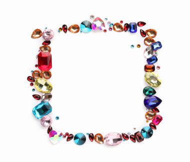 Beyaz arka planda, düz zeminde farklı parlak değerli taşların çerçevesi. Metin için boşluk