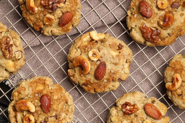 Tasty cookies with nuts on table, top view
