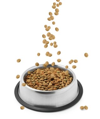 Dry pet food falling into bowl on white background clipart