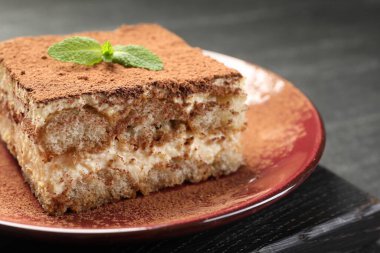 Karanlık masadaki naneli nefis tiramisu, yakın plan.