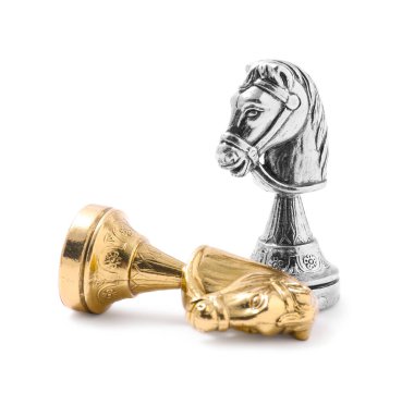 Golden chess knight near fallen silver one on white background. Competition concept clipart