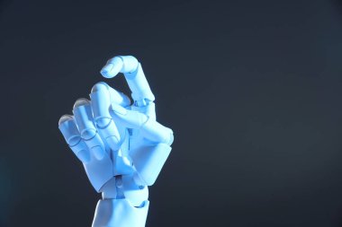 Yapay zeka. Gri arkaplanda el hareketi yapan robot el, metin için boşluk