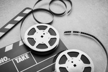 Sinema alkışları ve film makaraları gri desenli masa üzerinde, yakın plan