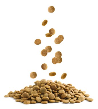 Dry pet food falling onto heap on white background clipart