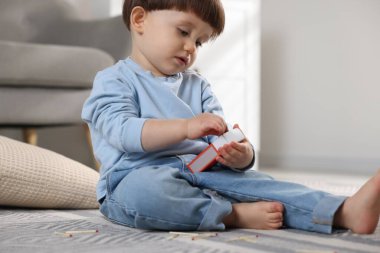 Küçük çocuk evde kibrit kutusuyla oynuyor. Çocuk tehlikede.