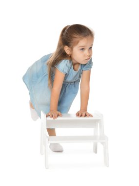 Little girl with step stool on white background clipart