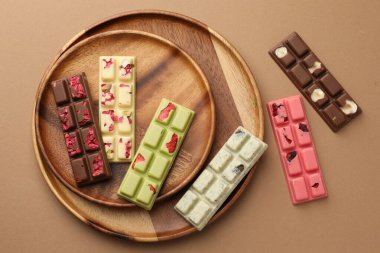 Bej arka planda farklı lezzetli çikolatalar, düz yatış.