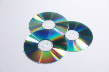 Many shiny compact discs on light background clipart