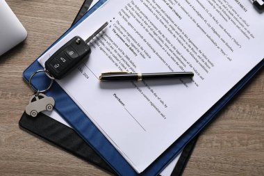 Araba anahtarı, satın alma sözleşmesi ve dizüstü bilgisayar, ahşap masa, düz konum. Otomatik satın alınıyor