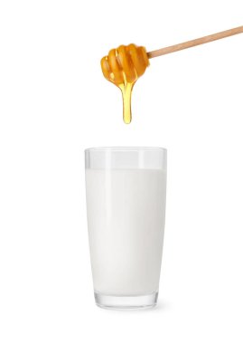 Honey dripping from dipper into glass of milk on white background clipart