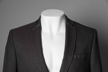 Semi-ready jacket on mannequin against grey background, closeup clipart