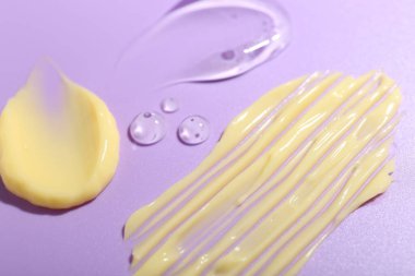 Menekşe arka planda krem ve jel örnekleri, yakın plan