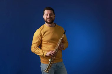 Mavi arka planda soprano saksafonu olan profesyonel müzisyen.