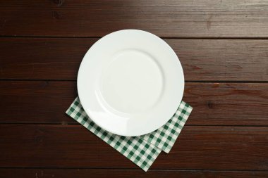 Damalı peçete ve boş tabak ahşap masa, üst görünüm