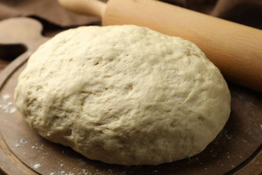 Taze hamur ve merdane masaya, yakın plan.