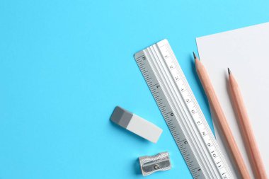 Açık mavi arkaplan üzerinde cetvel ve diğer kırtasiye düz bileşimi, metin için boşluk