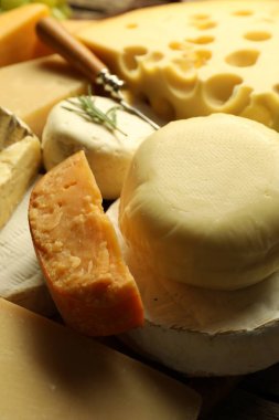 Different types of cheese on table, closeup clipart