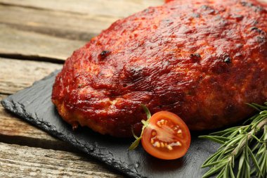 Ahşap masada domates ve biberiyeli lezzetli hindi köftesi, yakın plan.