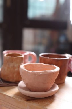 Kapalı alandaki ahşap rafta güzel bir çömlek.