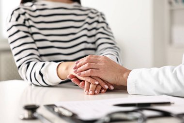 Hastane randevusu sırasında hastaya bakan doktor, ellerinizi kapatın.