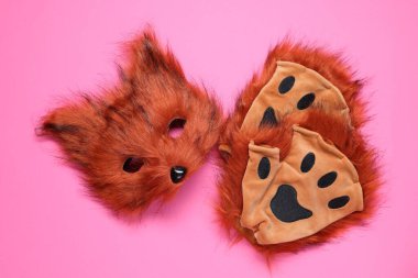 Quadrobics. Fox mask and gloves on pink background, flat lay clipart