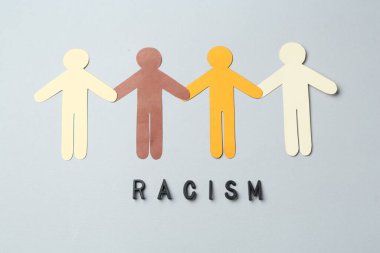 Word Racism and human paper figures of different colors on light grey background, top view clipart