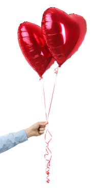 Beyaz arka planda kalp şeklinde kırmızı balonlar tutan adam, yakın plan. Sevgililer Günü
