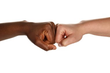 Stop racism. People of different skin colors bumping fists on white background, closeup clipart