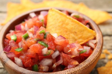 Masada nefis salsa ve cips var, yakın plan.