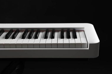 Synthesizer on black background, closeup. Electronic musical instrument clipart