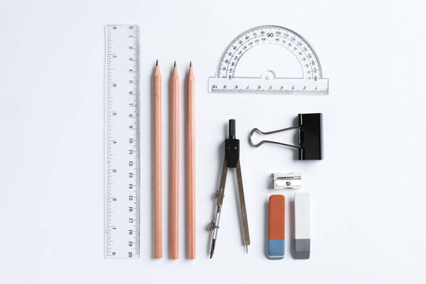 Flat lay composition with ruler and other stationery on white background
