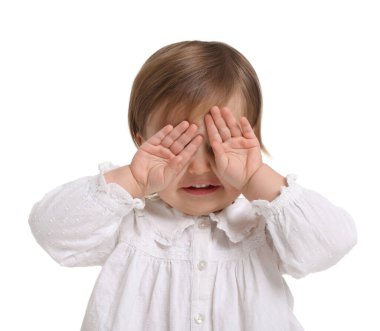 Beyaz arka planda peekaboo oynayan tatlı küçük kız.