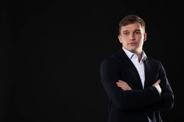 Siyah arka planda klasik takım elbiseli bir adam. Metin için boşluk