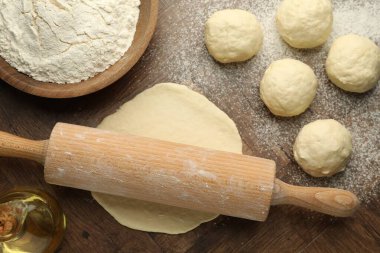 Taze hamur, merdane, un ve yağ ahşap masa, düz uzanmış