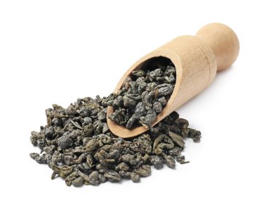 Tahta kepçenin içindeki kuru çay yaprakları beyaza izole edilmiş.