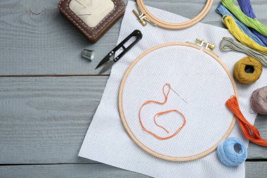 Gri ahşap masaya nakış işlemek için farklı dikiş malzemeleri. Metin için boşluk