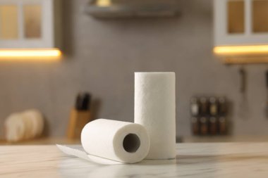 Rolls of paper towels on white marble table in kitchen
