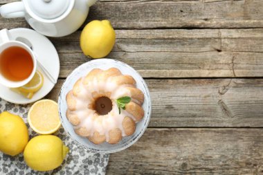 Lezzetli limonlu pasta, cila, çay ve ahşap masada taze meyveler, düz yatak. Metin için boşluk