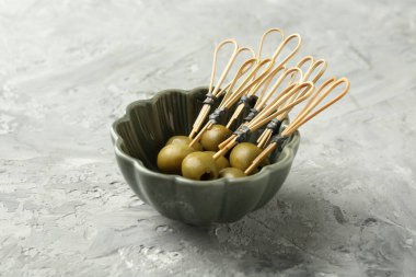 Gri dokulu masada salamura edilmiş zeytinler, yakın plan.