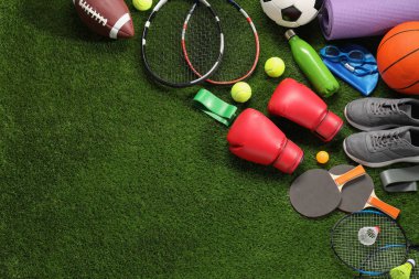 Yapay çimenlerin üzerinde farklı spor aletleri var. Metin için boşluk